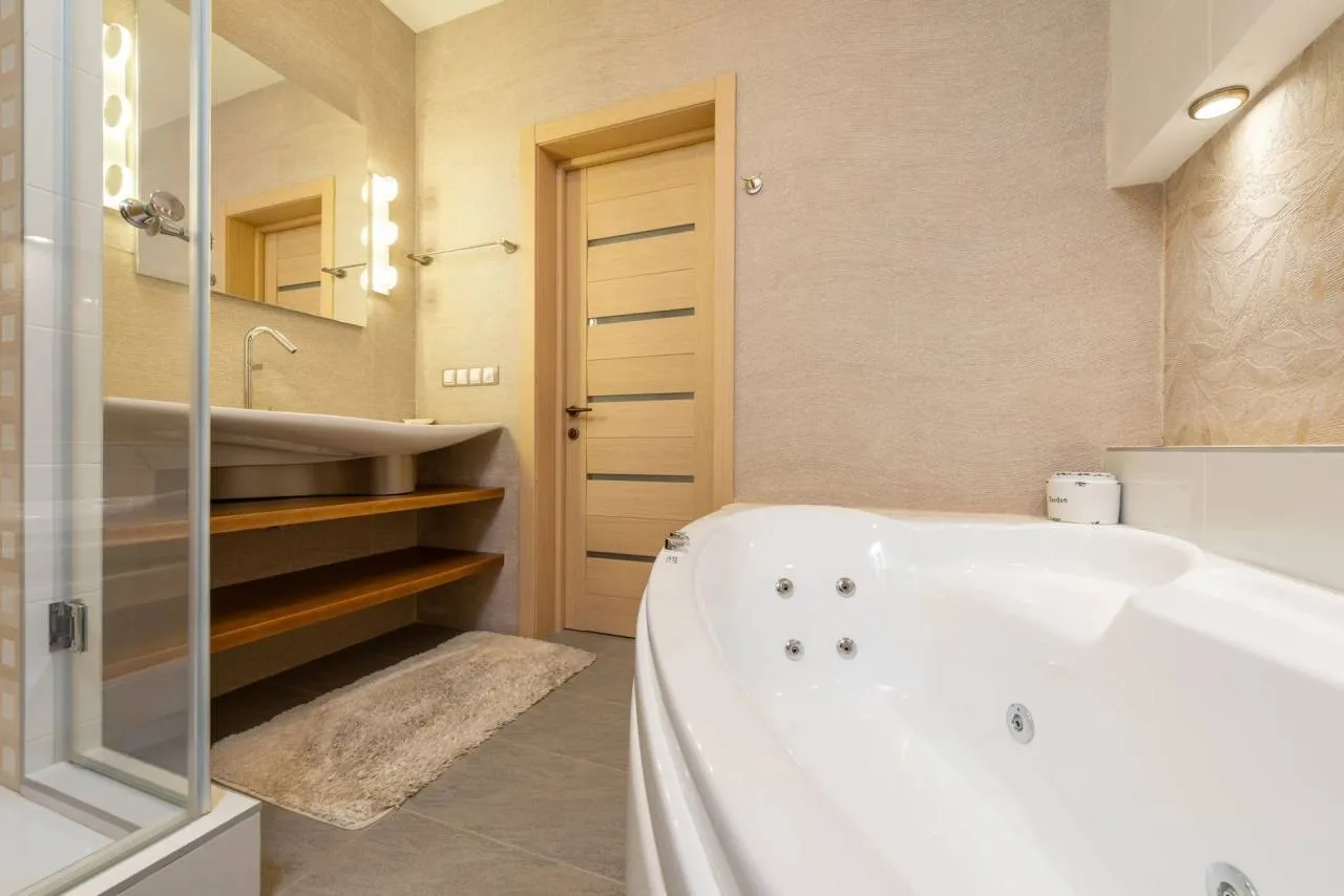 Modern bathroom with both a bathtub and glass-enclosed shower
